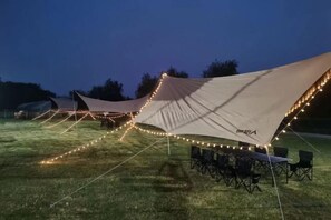 A series of tents with string lights, arranged on a grassy field. - Mingzhu Lake Swan Garden Resort (Shanghai)
