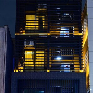 A multi-story building with horizontal slats and windows. - BRILLIANCE HOTEL (Nagoya)