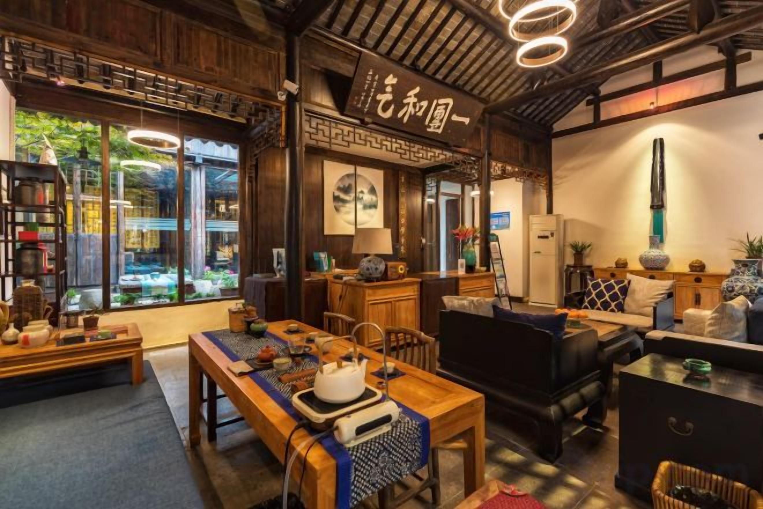 A traditional Japanese-style room with tatami flooring, a low table, and a sofa.