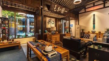 A traditional Japanese-style room with tatami flooring, a low table, and a sofa.