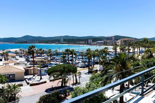 A coastal resort with a marina, beach, and palm trees.