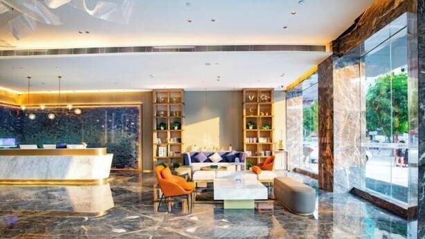 A modern lobby with a reception desk, seating area, and large windows. - Blueprint Cloud Hotel (Shenzhen Longcheng Plaza subway station store) (Shenzhen)