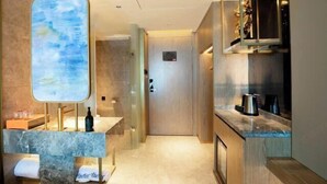 A modern hotel room with a marble bathroom, a wooden door, and a kitchen area with a coffee maker. - Blueprint Cloud Hotel (Shenzhen Longcheng Plaza subway station store) (Shenzhen)