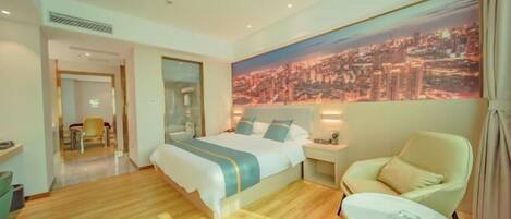 A hotel room with a large bed, a chair, a small table, and a cityscape view.