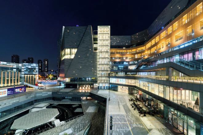 Un edificio moderno de varios pisos, con amplios ventanales y un patio central.