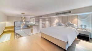 A modern bedroom with a large bed, a glass partition, and a minimalist design. - Humgait Hotel (Hangzhou)