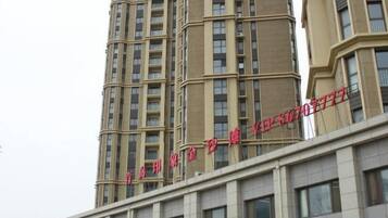 A multi-story building with a prominent sign in red characters.