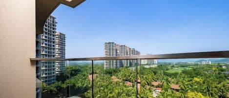 A balcony with a clear view of surrounding buildings and greenery.