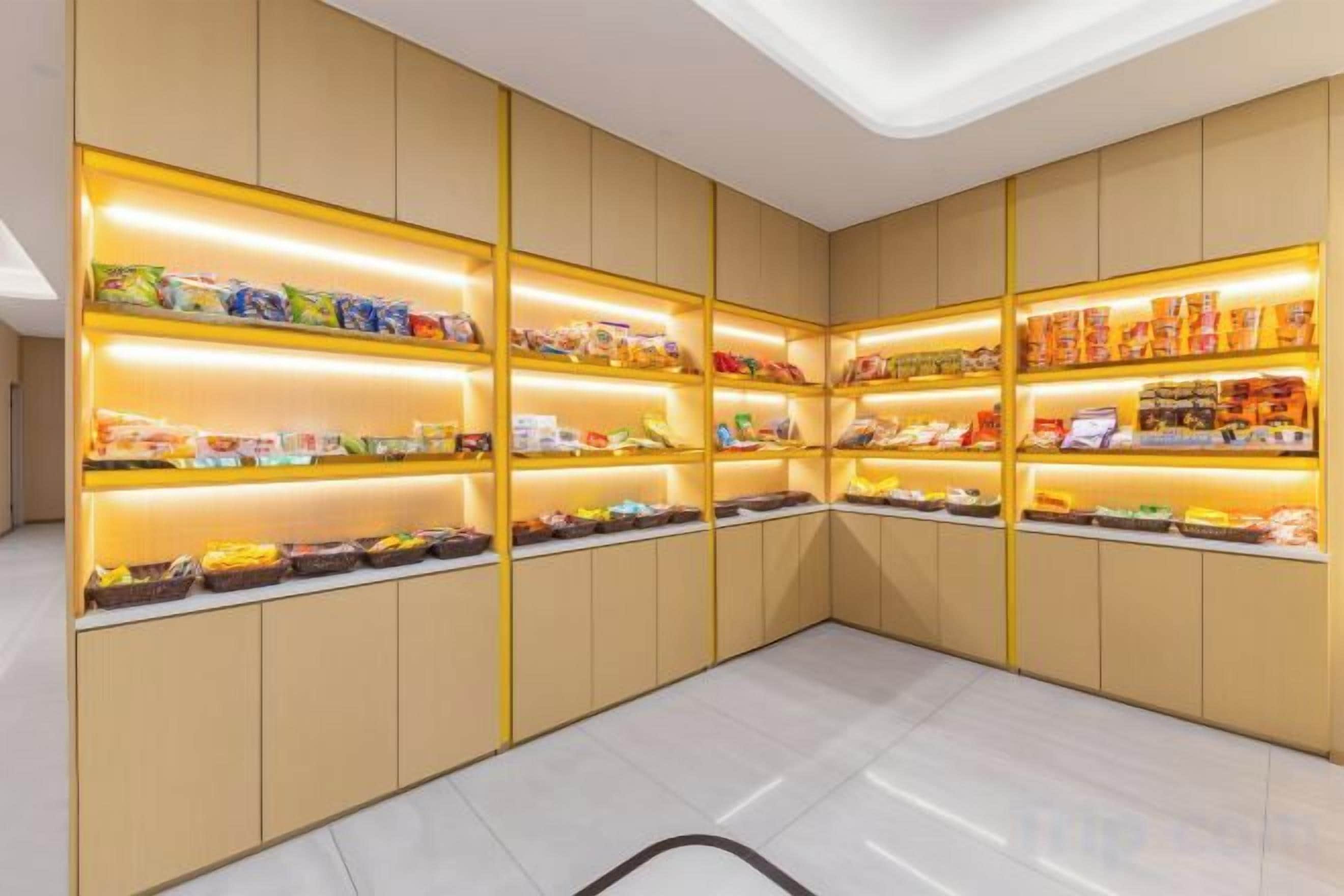 A room with multiple shelves displaying various packaged goods.