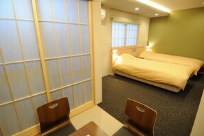 A hotel room with two beds, a sliding shoji screen, a small table, and a chair. - Hiz Hotel Kyoto-Nijo Castle (Kyoto)