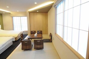 A hotel room with a bed, a dining table with chairs, and a large window with blinds. - Hiz Hotel Kyoto-Nijo Castle (Kyoto)