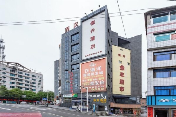 A multi-story hotel with signage indicating amenities and services.