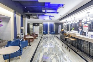 A modern hotel lobby with a marble floor, seating areas, and a reception desk. - Zunyi Hengsheng Hotel (Yuqing)