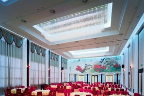 A spacious banquet hall with rows of tables and chairs, large windows, and a decorative ceiling. - Anhui Construction New Era Hotel (Feidong)