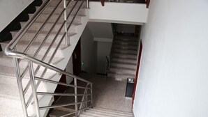A staircase with metal railings and carpeted steps leading to an upper floor. - pingnanxianbaoshanbibgguan (Pingnan)