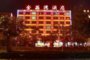 A multi-story hotel with illuminated signage and a well-lit facade. - Jinliwan Hotel (Sanya)