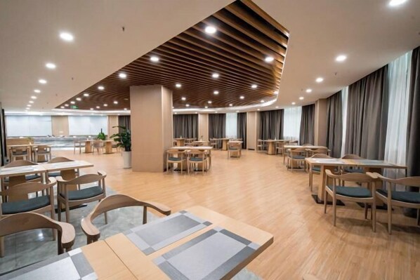 A spacious dining area with wooden tables and chairs, a modern ceiling design, and large windows with curtains. - Xinhua Hotel Nanchuan (Chongqing)