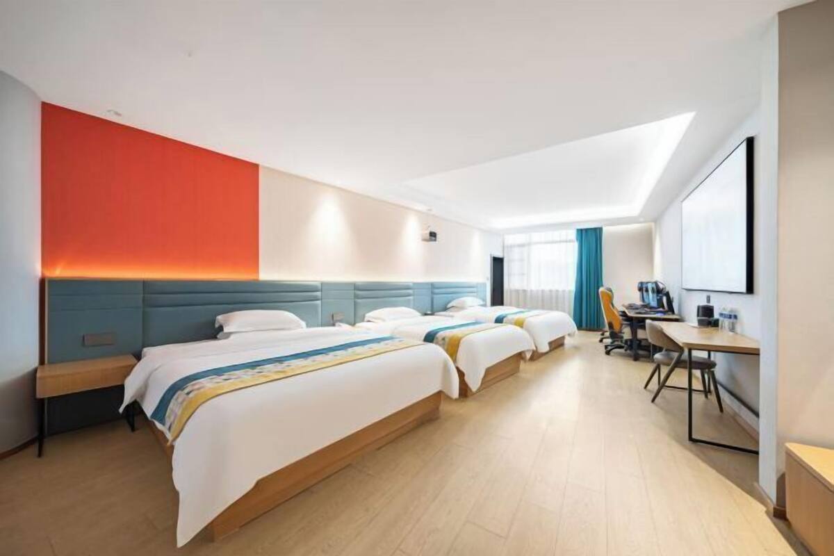 Een hotelkamer met een groot bed, een bureau en een stoel.