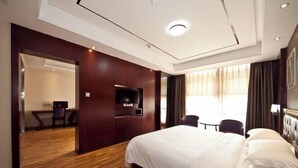 A hotel room with a large bed, a desk, a chair, a TV, and a window with curtains. - Fuqing New Port Express Hotel (Fuqing)