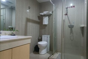 A modern bathroom with a toilet, sink, and glass shower enclosure. - Fuqing New Port Express Hotel (Fuqing)