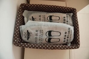 Eine Schachtel mit zwei darin befindlichen Gegenständen, verziert mit japanischen Schriftzeichen und einem Kompassdesign.