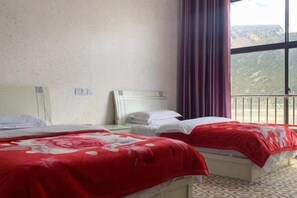 A hotel room with two beds, a large window, and a balcony. - HaiziMountainGrandHotel (Daocheng County)