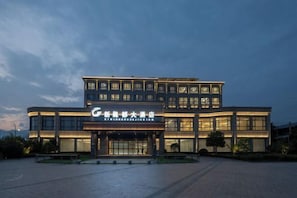 A modern hotel with a prominent entrance and multiple floors.
