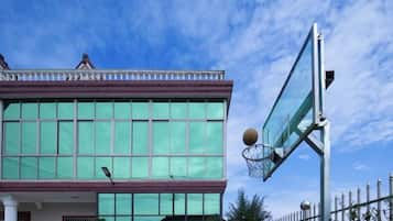 A building with large windows and a basketball hoop.