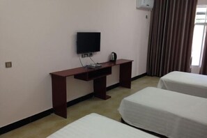 A hotel room with a single bed, a desk with a television, and a window with curtains. - Chibi Ancient Wind Hotel (Chibi)