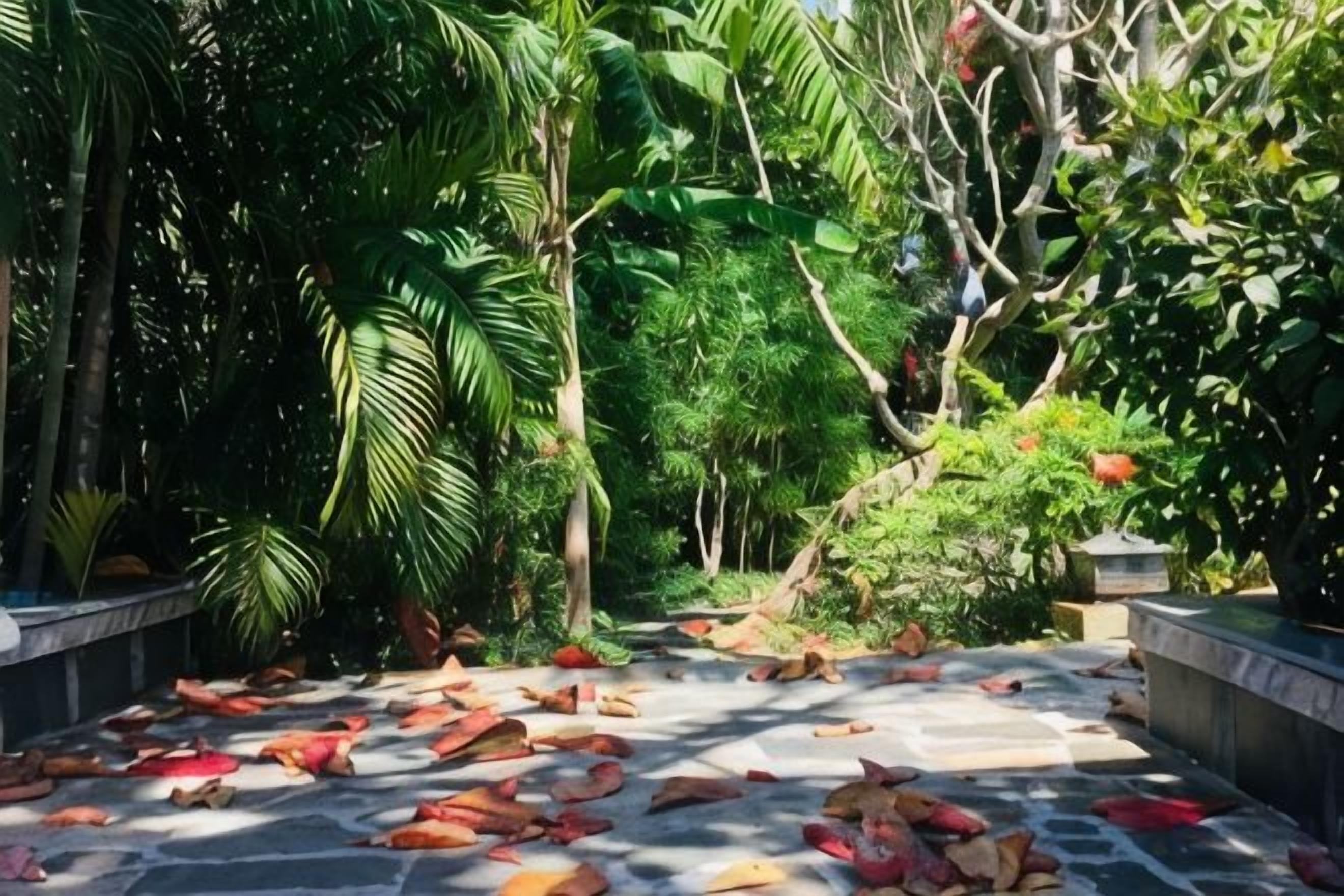 A stone pathway surrounded by lush greenery and trees.