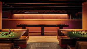 A billiards room with two tables and seating. - Residences at Snow King (Jackson)