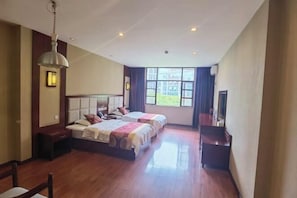 A hotel room with two beds, a wooden floor, a large window with a view, and a ceiling light. - Jiangcheng Lindeng Hotel (Jiangcheng)