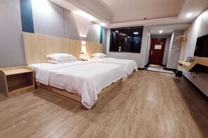 A hotel room with two beds, a wooden headboard, a bedside table, a TV, and a large window. - Maple Leaf Hotel (Lipu) (Lipu)