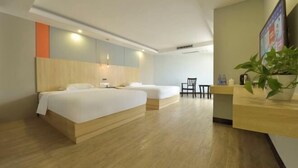 A hotel room with a wooden bed, a desk, and a chair.