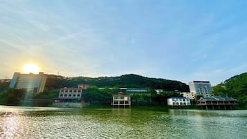 A lakeside view with buildings and a dock.