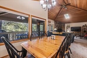 Enjoy meals in this dining area with a large table, comfortable chairs, and a high ceiling.