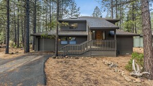 A two-story cabin with a covered porch and a staircase leading to the entrance. - 6 Lynx Sunriver (Sunriver)