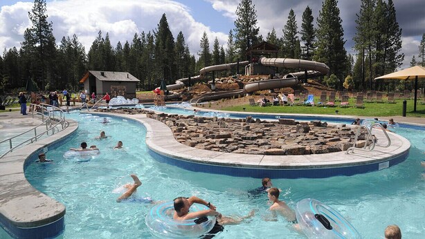 A swimming pool with multiple lanes, a water slide, and lounge chairs. - 6 Lynx Sunriver (Sunriver)