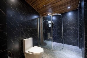 A modern bathroom with a glass-enclosed shower, dark marble walls, and a wooden ceiling. - the Four Seasons the Inn (Lijiang)