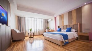A modern hotel room with a large bed, a desk, a chair, and a television. - Super 8 Hotel Zepu Fatong Park (Zepu)