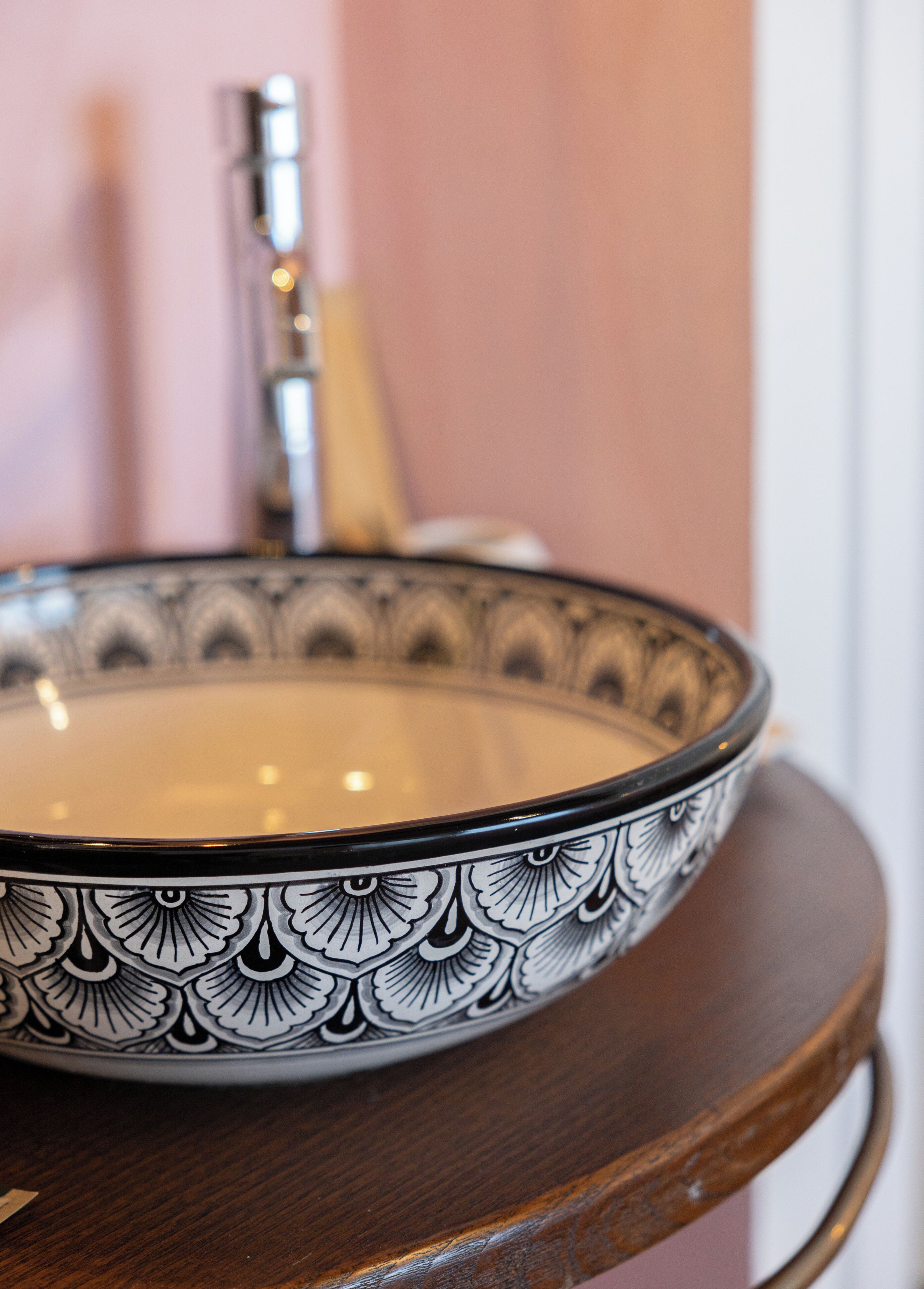 A bowl with a decorative pattern on a wooden surface.