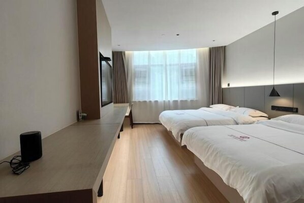 A hotel room with two beds, a desk with a speaker, and a large window with curtains. - Ningbo Daxiebaodao Island Hotel (Ningbo)