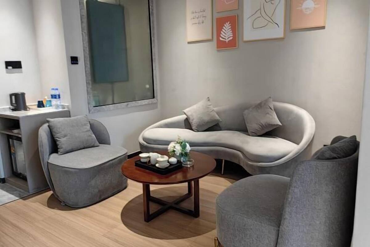 A modern living room with a sofa, armchair, and coffee table.