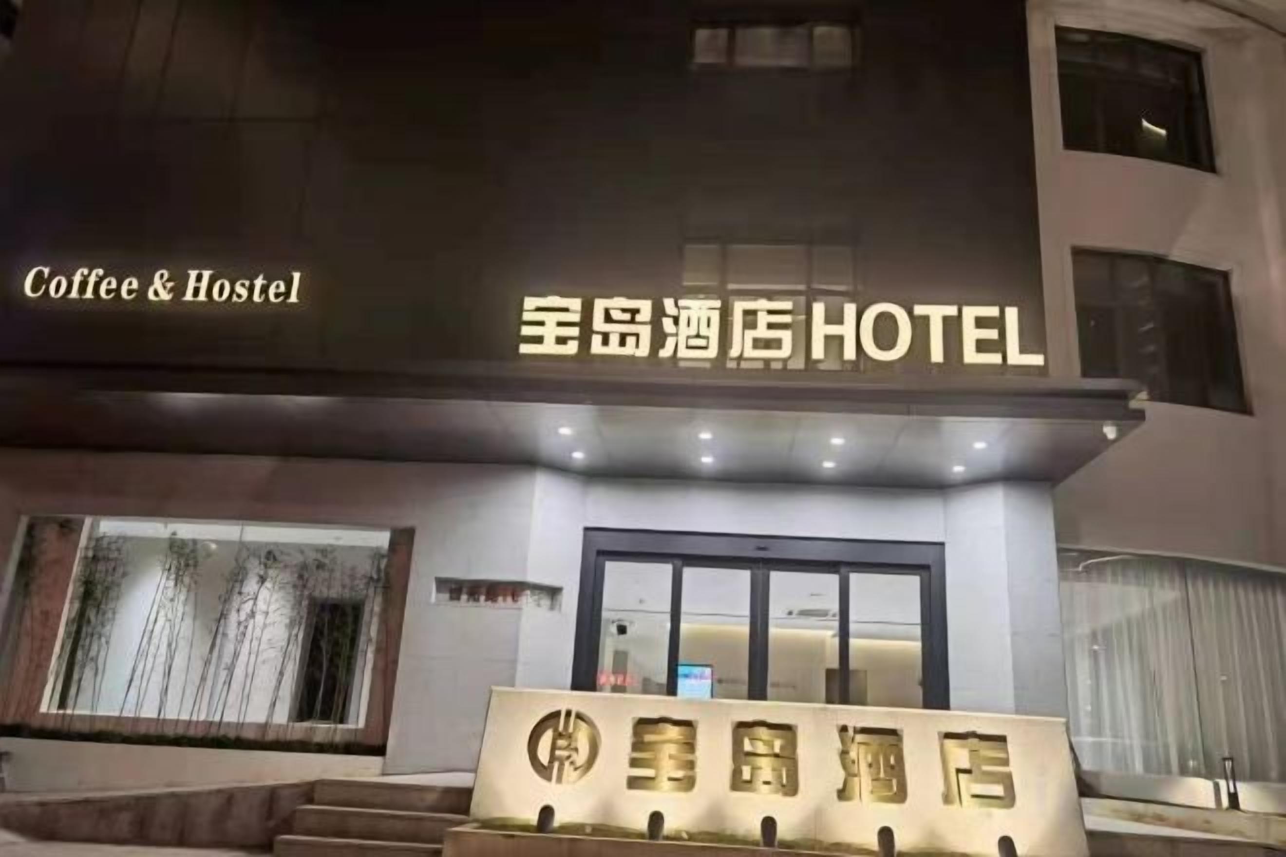 A hotel entrance with a sign indicating it's a 'Coffee & Hostel' and '星岛酒店HOTEL'.