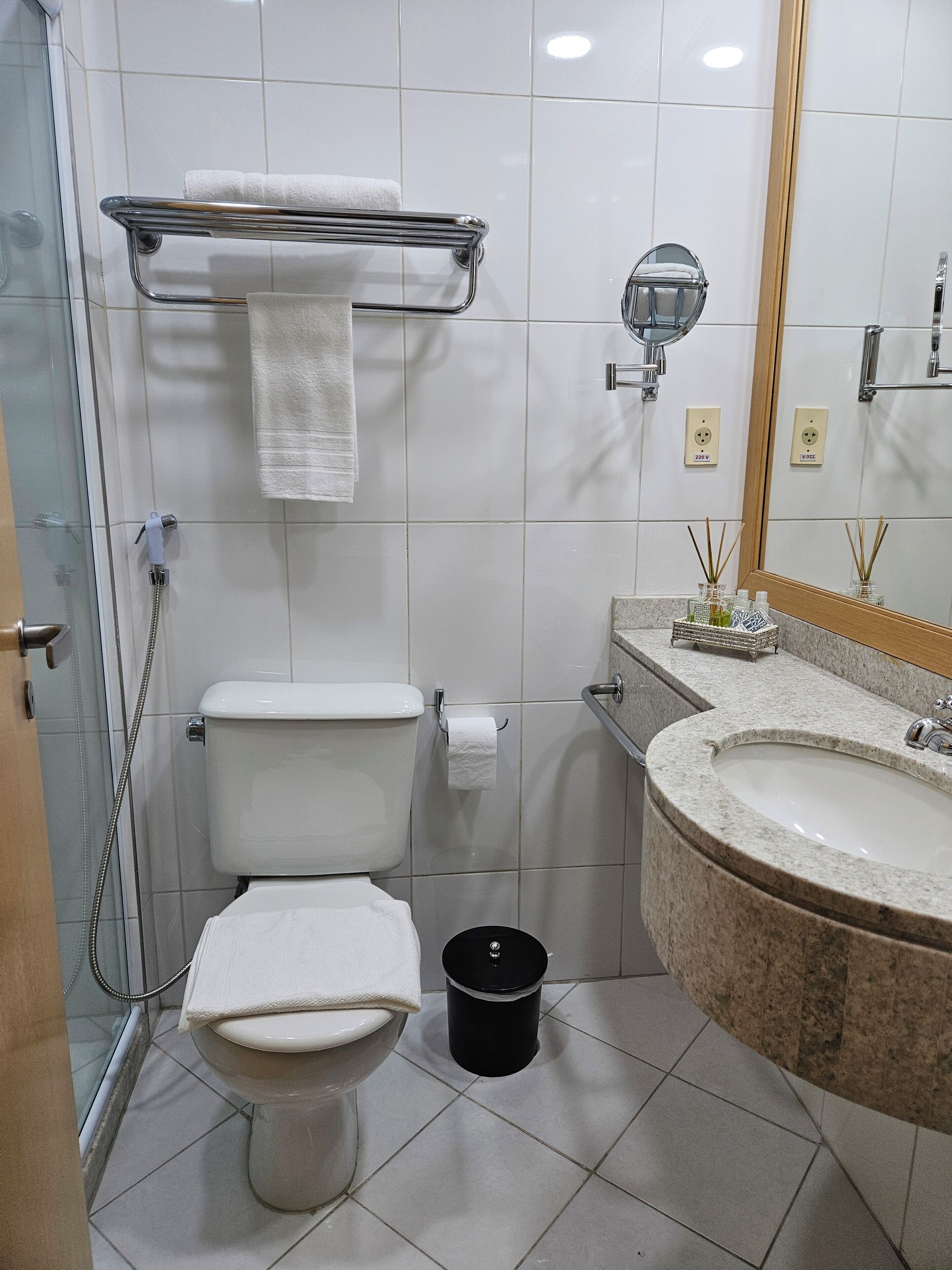 A modern bathroom with a toilet, bidet, and sink.