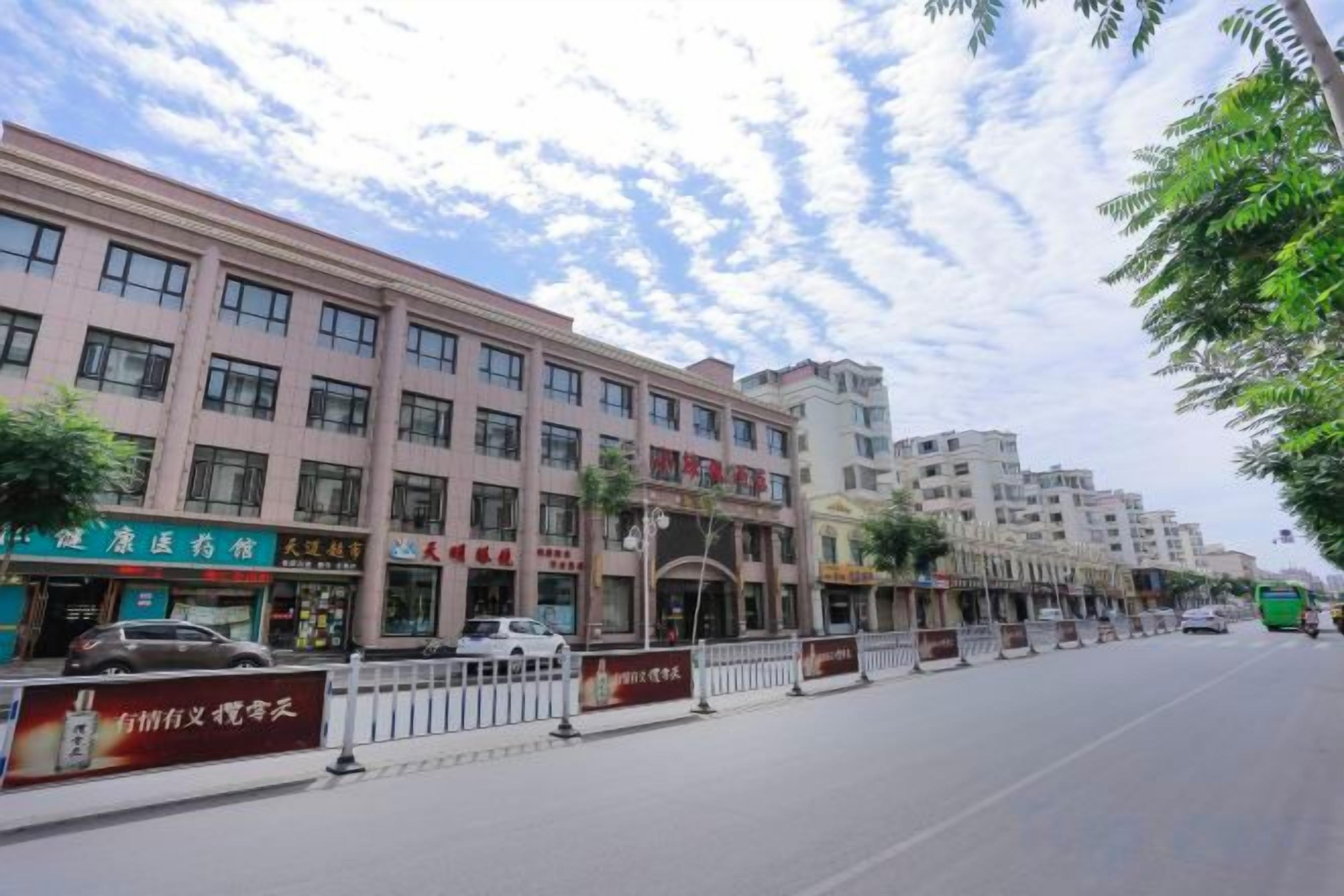 A multi-story building with commercial establishments on the ground floor, including a restaurant and a pharmacy.