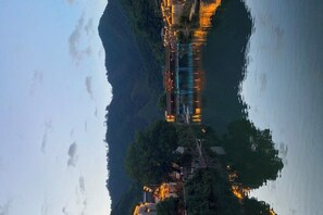 A serene riverside view with traditional architecture, a bridge, and a calm water body reflecting the buildings. - Huiyun Homestay, Yuli Ancient Town (Fuliang)