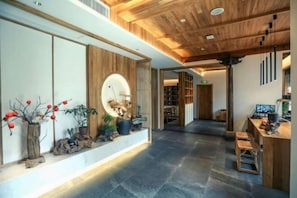 Relax in a serene space with a central island, seating area, and potted plants.