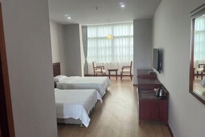 A hotel room with two beds, a desk, a chair, a television, and a large window with curtains. - AA Hotel Chain Lianyungang Jinxu Garden Branch (Lianyungang)