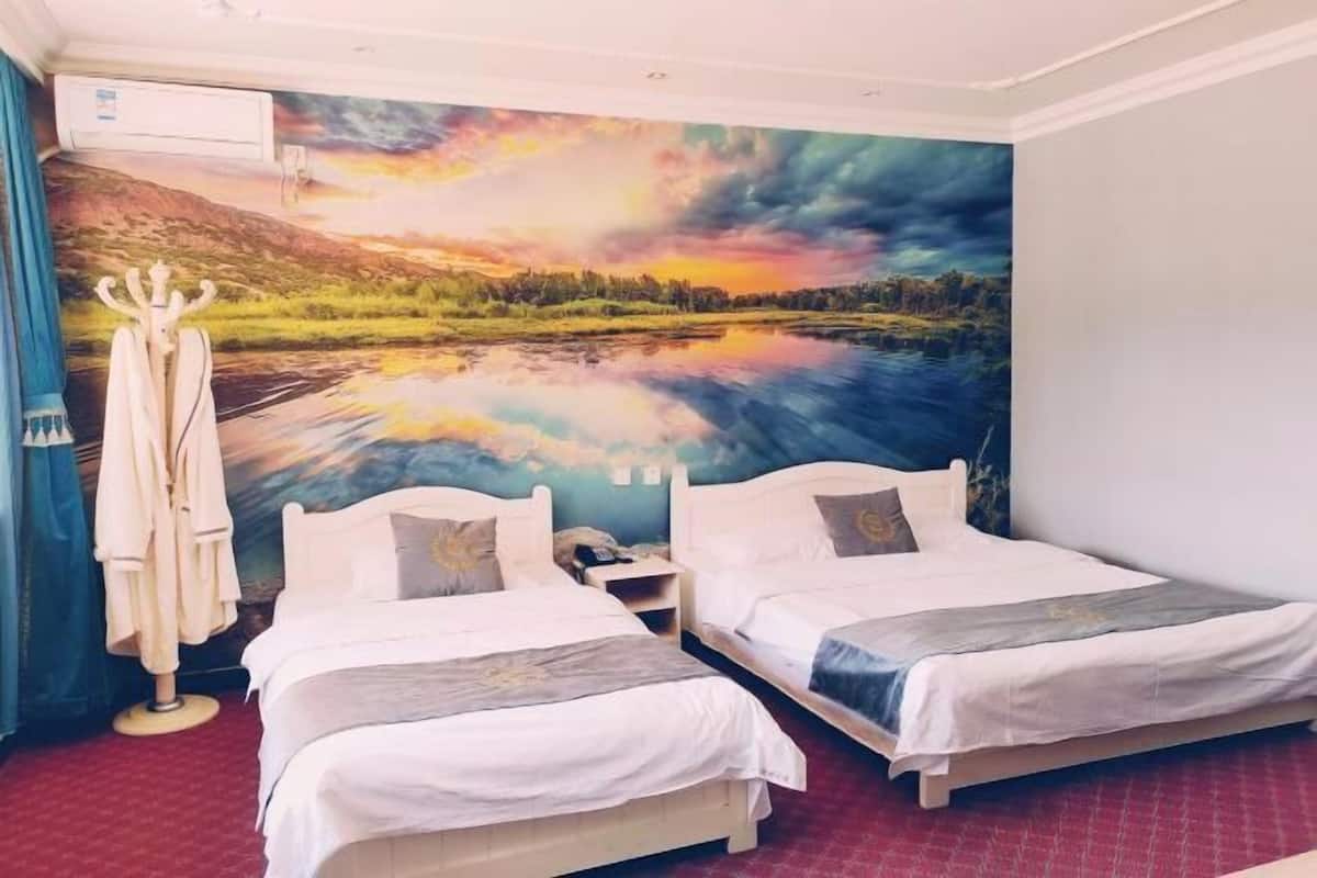 A hotel room with two beds, a large mural of a landscape, and a robe rack.